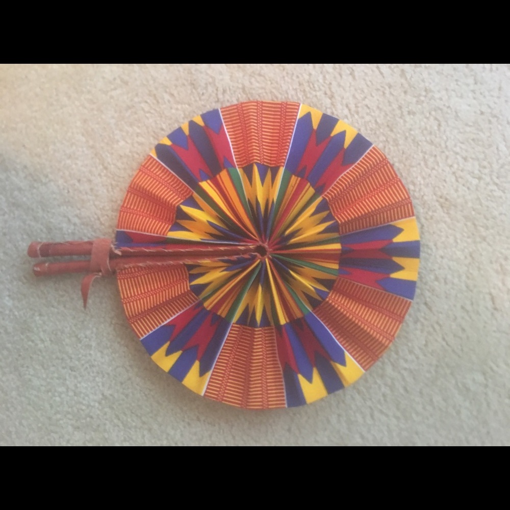 Beautiful folding leather and Kente cloth fan.